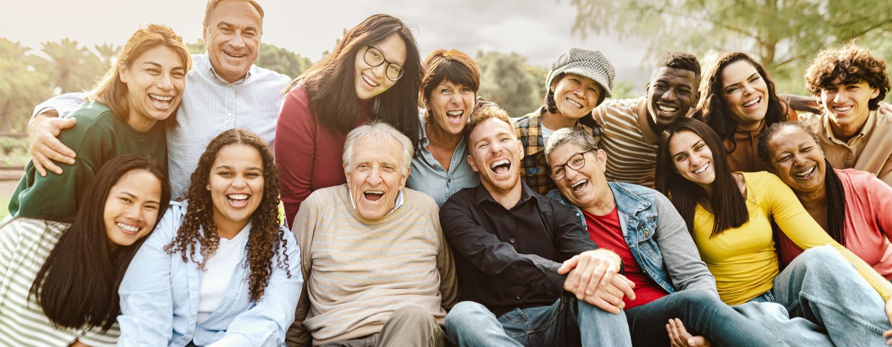 a group of people sitting together smiling