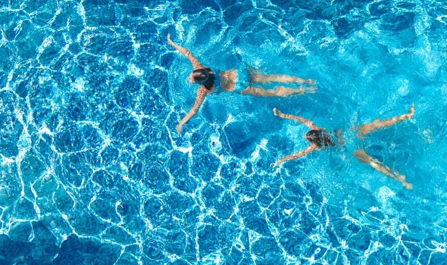 a group of people swimming in water