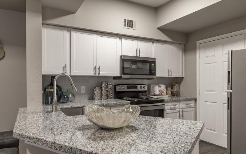 a kitchen with marble counters