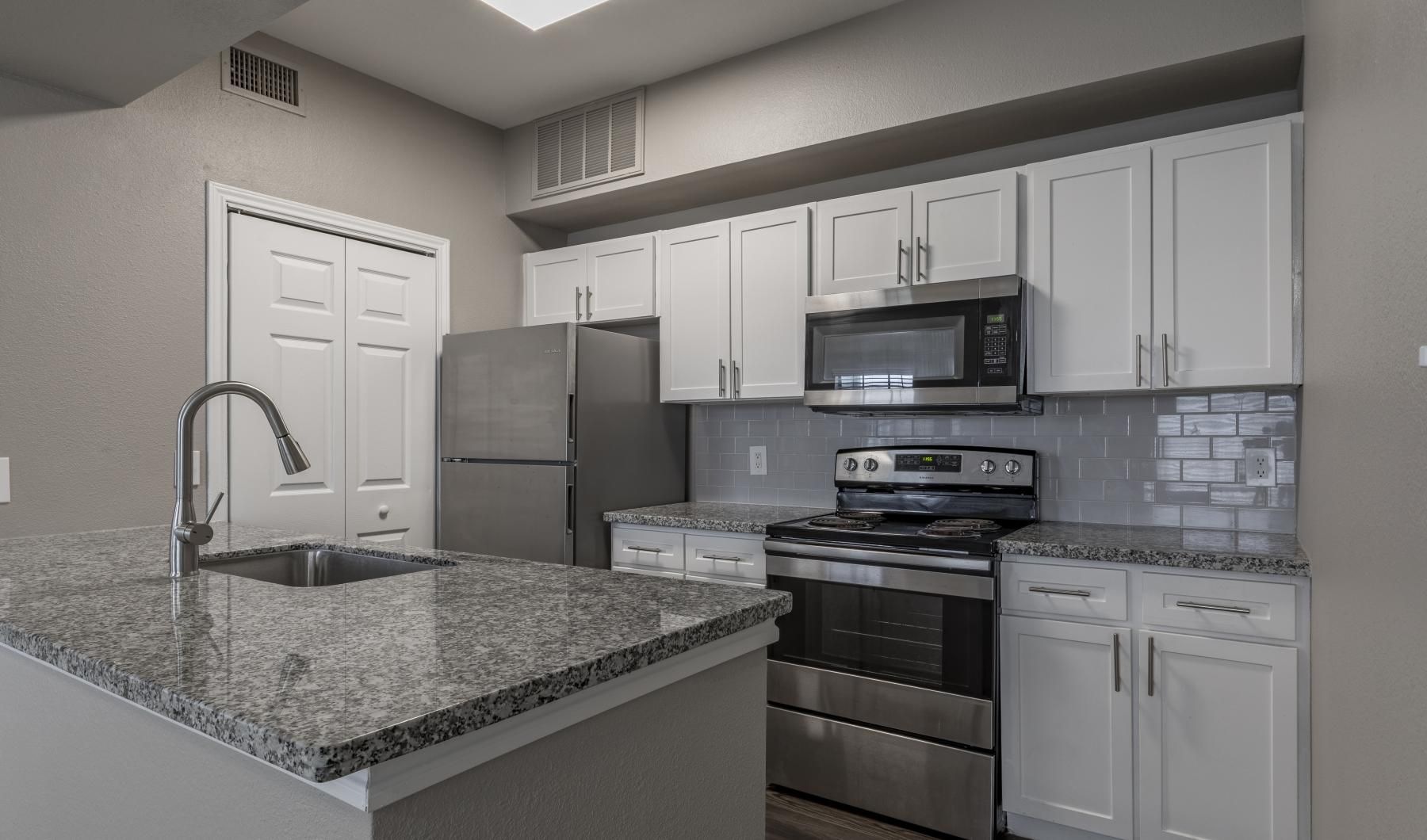 a kitchen with white cabinets